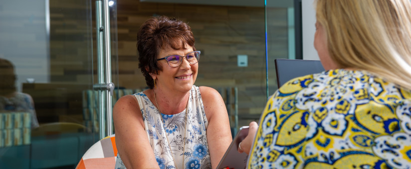 Receptionist talking to a patient