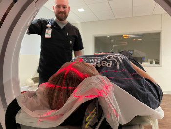 Radiology staff member preparing a patient for a scan